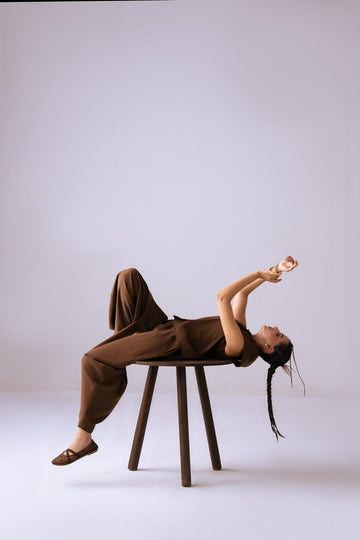 The Cocoa Ease Top - full length seated on stool
